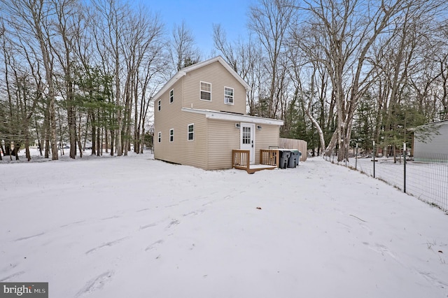 view of snow covered rear of property