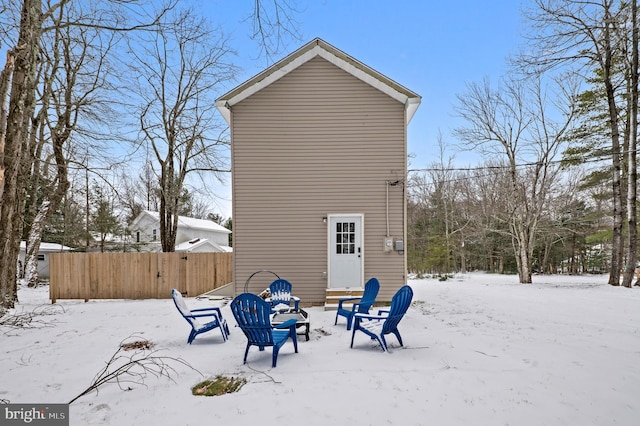 view of snow covered rear of property