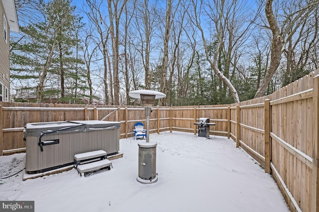 exterior space with a hot tub and a grill