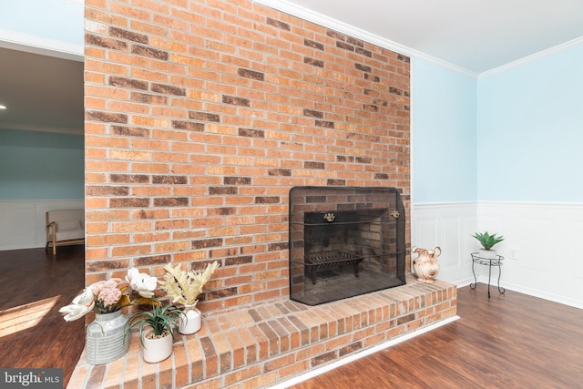 interior details featuring a brick fireplace, hardwood / wood-style floors, and ornamental molding