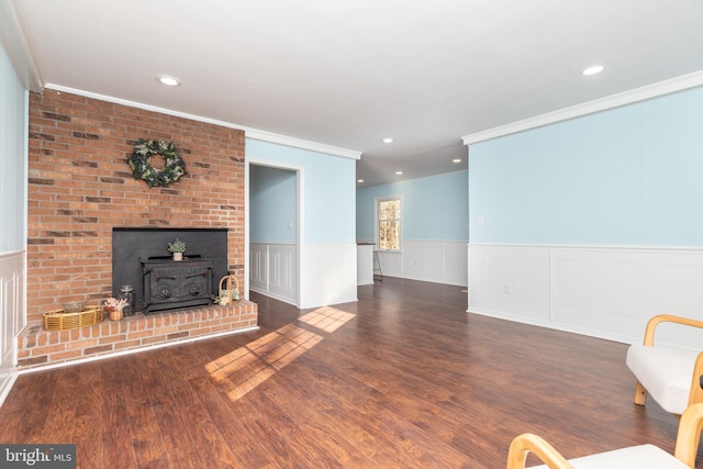 unfurnished living room with dark hardwood / wood-style floors, a wood stove, and ornamental molding