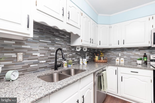 kitchen with white cabinets, stainless steel dishwasher, ornamental molding, and sink