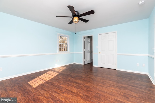 unfurnished room featuring ceiling fan and dark wood-type flooring