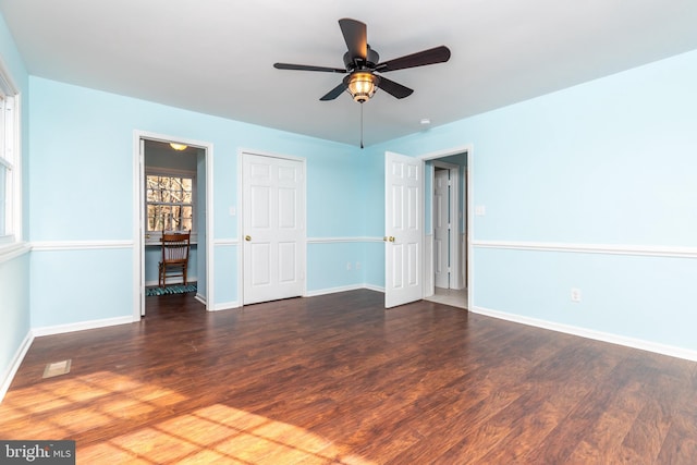 spare room with dark hardwood / wood-style flooring and ceiling fan