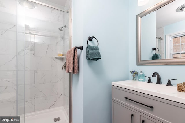 bathroom featuring vanity and an enclosed shower