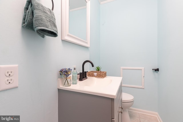 bathroom featuring tile patterned flooring, vanity, and toilet