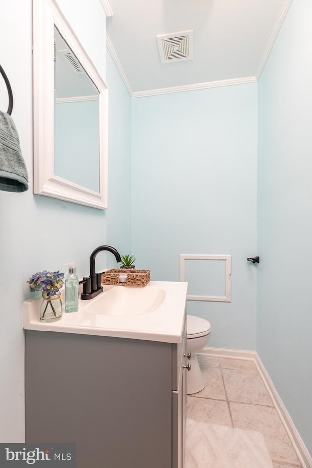 bathroom featuring tile patterned flooring, vanity, toilet, and ornamental molding