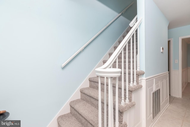 stairway featuring tile patterned flooring