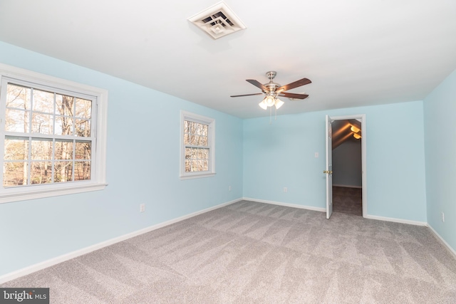 unfurnished room with light colored carpet and ceiling fan