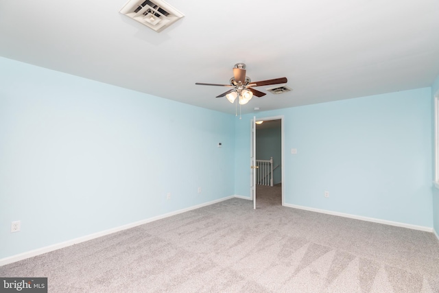 spare room featuring carpet floors and ceiling fan