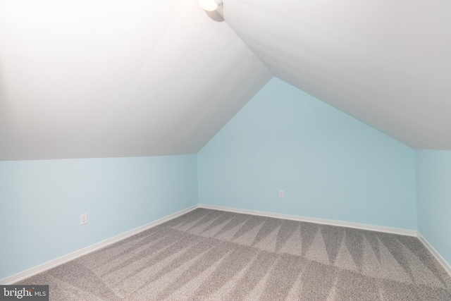 bonus room with carpet flooring and lofted ceiling