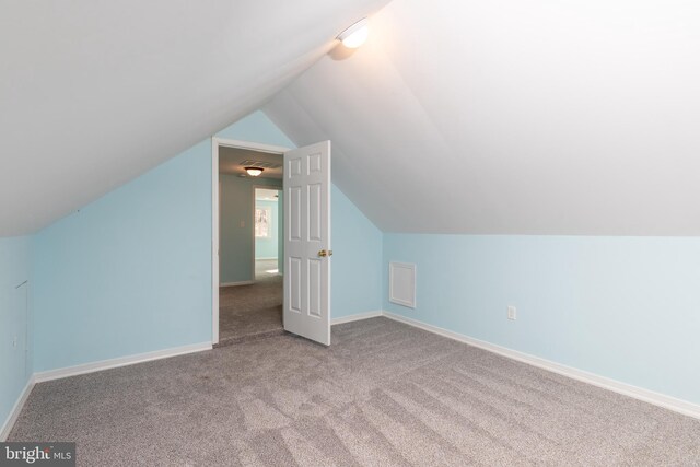 bonus room featuring light colored carpet and vaulted ceiling