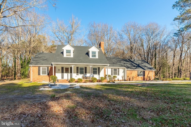 cape cod-style house with covered porch and a front yard