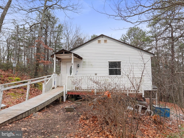 rear view of house featuring a deck