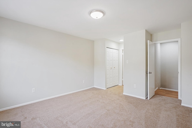 unfurnished bedroom featuring light carpet