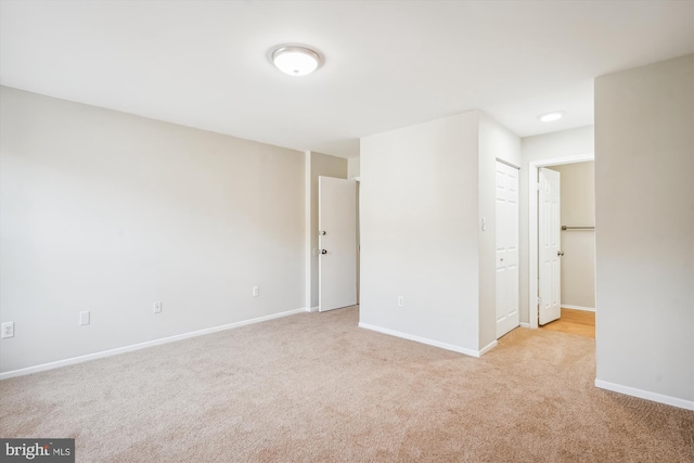 unfurnished room with light colored carpet