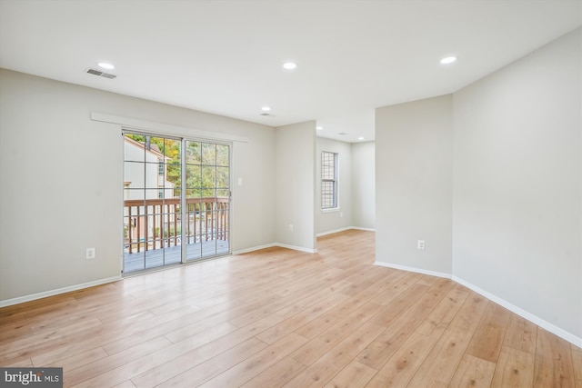 spare room with light hardwood / wood-style flooring