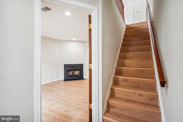 stairs with hardwood / wood-style floors