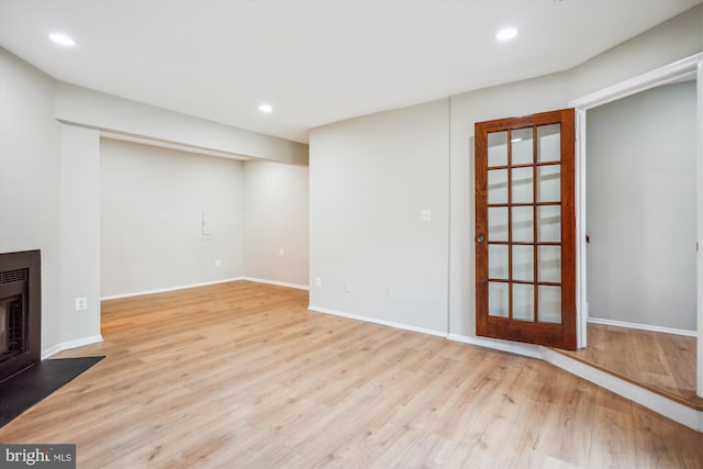 basement featuring light wood-type flooring