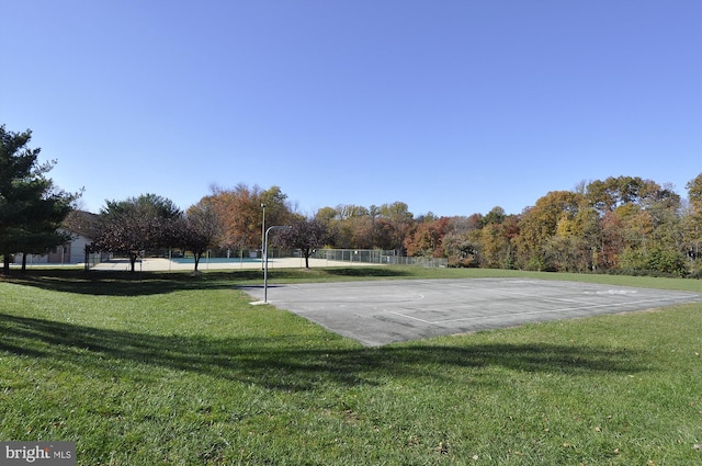 view of property's community with a yard and basketball court