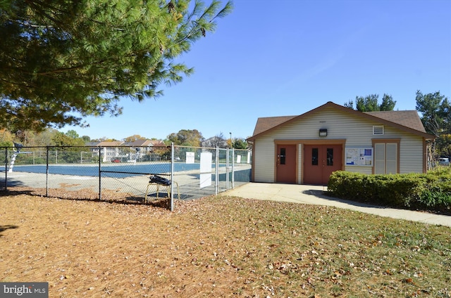 view of swimming pool featuring tennis court