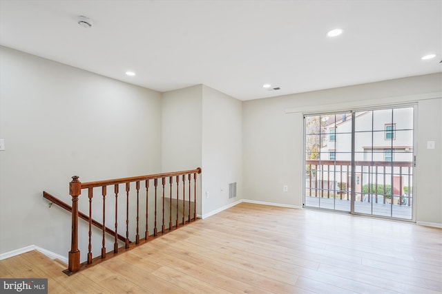 empty room with light hardwood / wood-style flooring