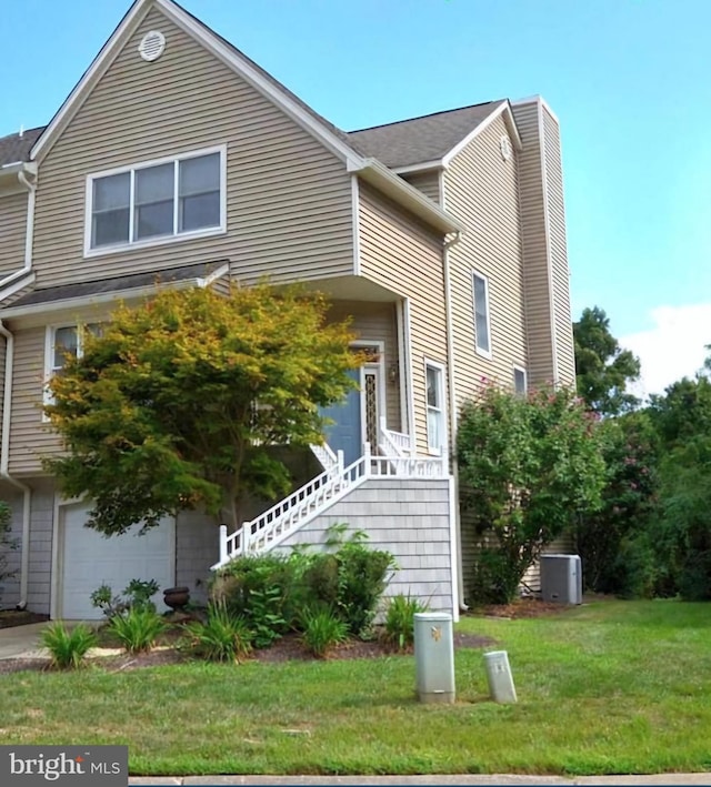 view of side of home with a garage and a lawn