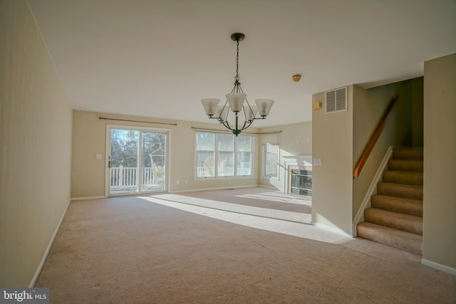 unfurnished dining area featuring light carpet and an inviting chandelier