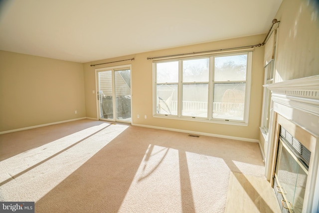 unfurnished living room featuring light carpet