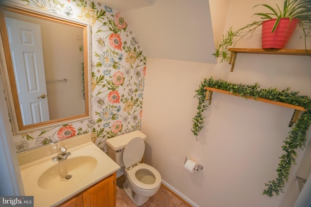 bathroom with tile patterned flooring, vanity, and toilet