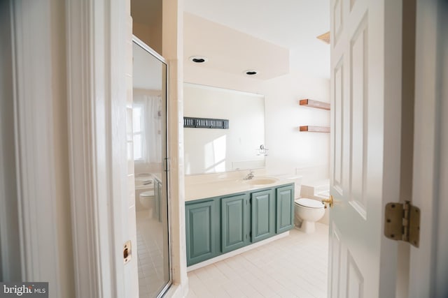 bathroom featuring tile patterned floors, vanity, toilet, and an enclosed shower