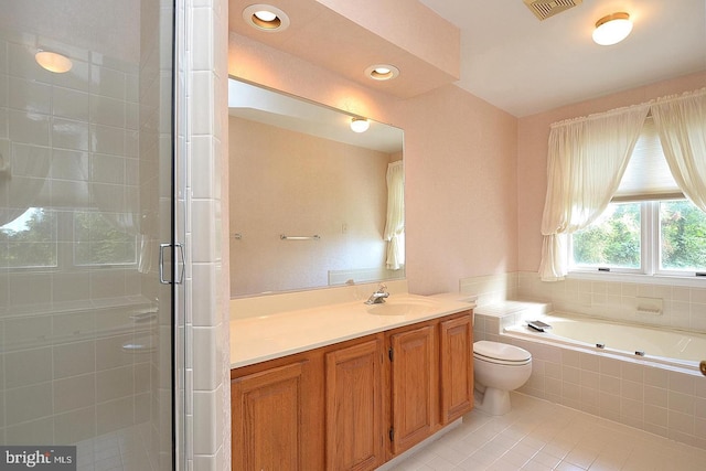 full bathroom with toilet, shower with separate bathtub, vanity, and tile patterned floors