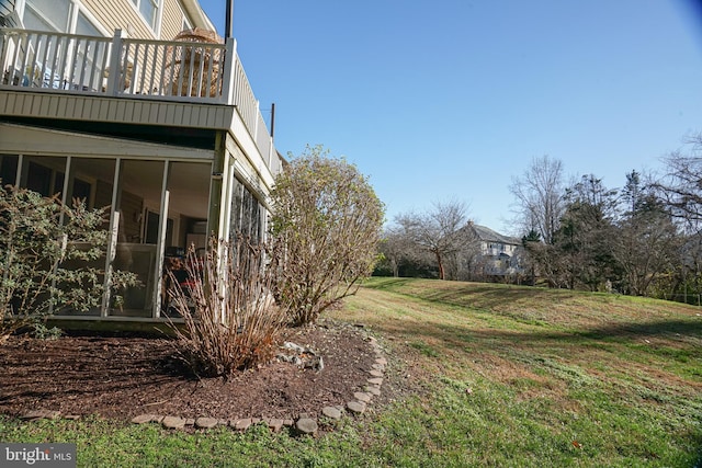 view of yard with a balcony