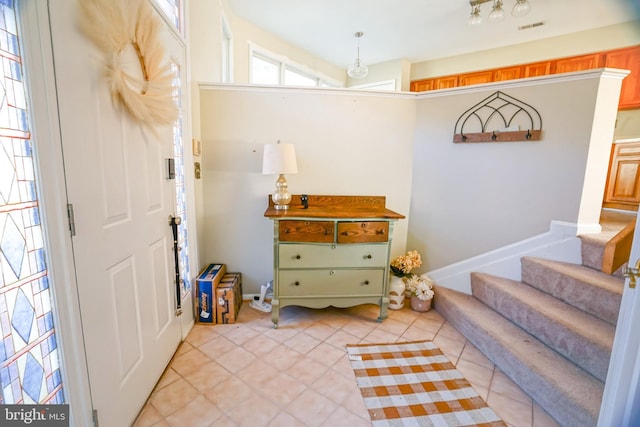 tiled entryway with plenty of natural light