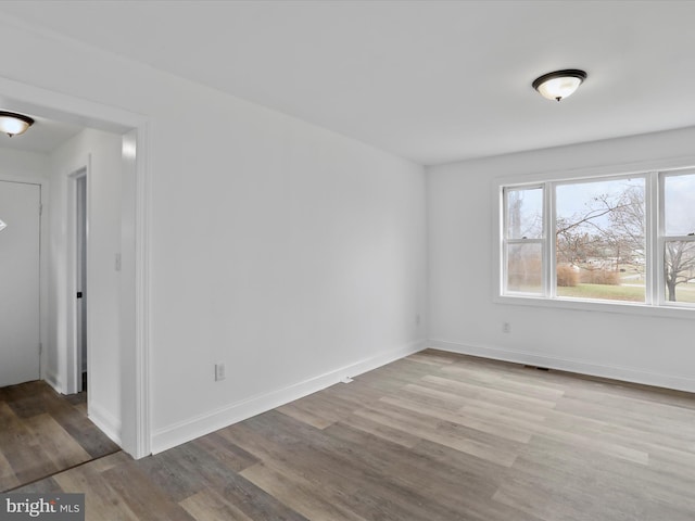 empty room with hardwood / wood-style floors