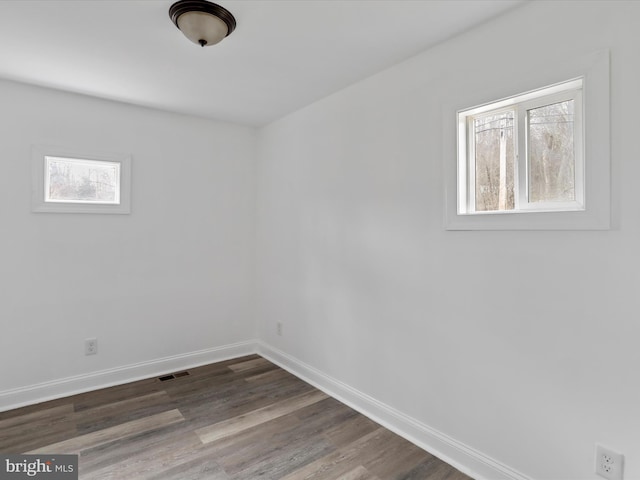 spare room with dark hardwood / wood-style flooring