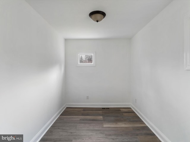 unfurnished room with dark hardwood / wood-style floors