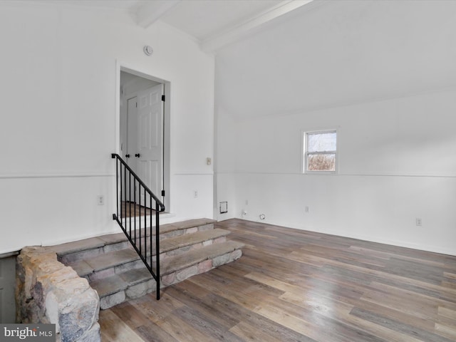 stairs with vaulted ceiling with beams and wood-type flooring