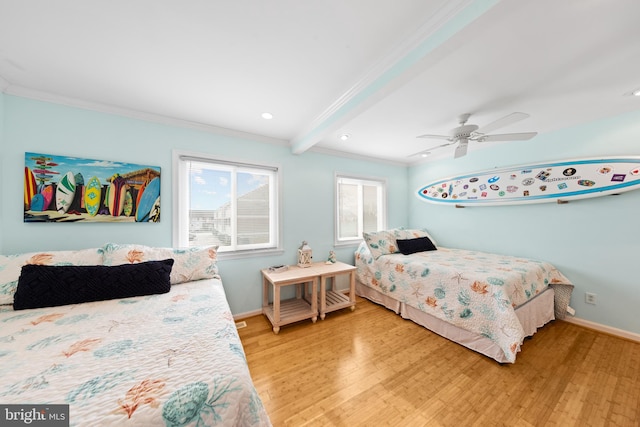 bedroom with beam ceiling, ceiling fan, crown molding, and hardwood / wood-style flooring