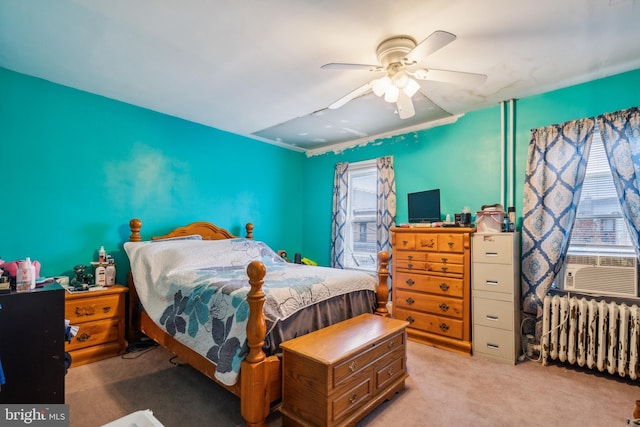 bedroom with ceiling fan, cooling unit, light carpet, and radiator