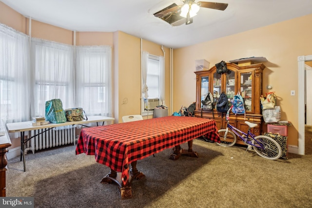 playroom featuring carpet, radiator heating unit, ceiling fan, and cooling unit