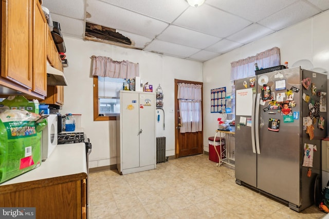 kitchen with white fridge, a drop ceiling, and stainless steel fridge