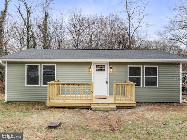 view of front of house featuring a deck and a front lawn