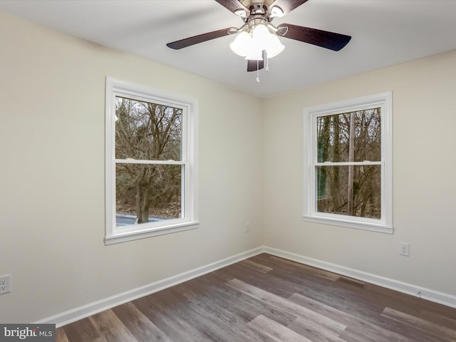 empty room with hardwood / wood-style floors and ceiling fan