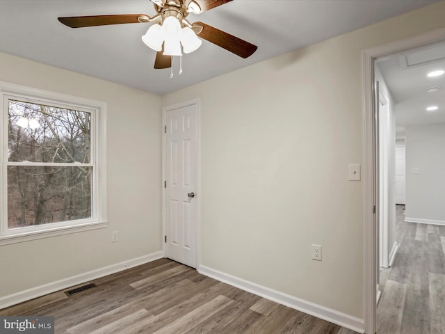 unfurnished bedroom with ceiling fan and wood-type flooring