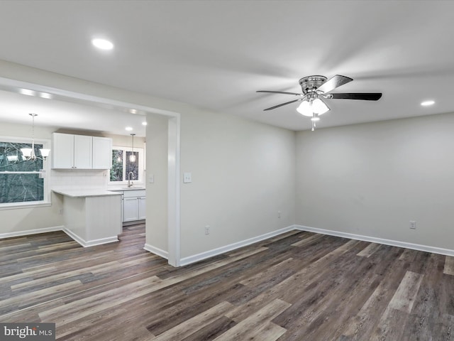 unfurnished room with ceiling fan, dark wood-type flooring, and sink