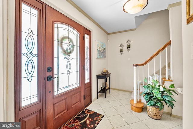 entryway with crown molding and light tile patterned flooring