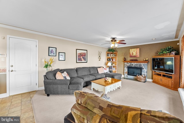 living room featuring ceiling fan, a fireplace, light colored carpet, and crown molding