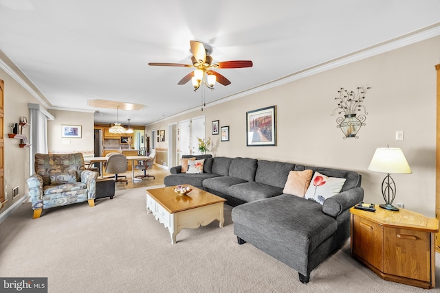 carpeted living room featuring ceiling fan and ornamental molding