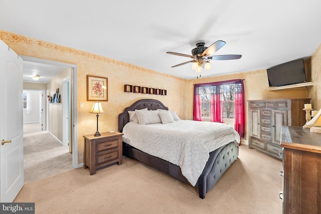 bedroom featuring light carpet and ceiling fan